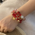 Detail of red and gold beaded multilayer bracelet with Love heart charm on female wrist - Heart Eiffel Tower Charm Style / Red (2# Red)