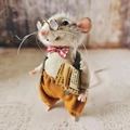 Detailed view of handmade needle felted mouse wearing glasses and a plaid bow tie - Grey Mouse-Brown Overalls-Holding Newspaper