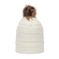 Detail view of winter knitted beanie featuring thick ribbed texture and faux fur pom-pom - White