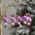 Dettaglio di ciondoli natalizi a spirale viola con glitter bianchi e perline rosse - Palla a Spirale Viola Bianco (5 pz/6cm)