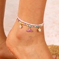 Detail of double-layer beaded anklet with flower and mermaid tail charms on a beach - Double Layer Rainbow Seed Beads Mermaid Tail Anklet (03 鱼尾 10521)