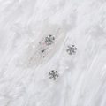Silver snowflake nail art charms with crystals on a white faux fur textured background - Style A1143-01