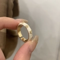 Close-up of golden sunflower ring with white enamel finish and zircon accents - Enamel Style