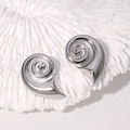 Silver conch shell earrings in high-polished stainless steel on a white coral base - Steel