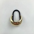 Sleek golden crescent metal hair tie with durable black elastic cord for ponytails - New Gold Large