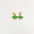 Macro detail of gold crown charms with green zircon inlay for DIY jewelry design - Green Zirconia