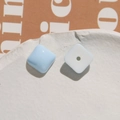 Macro shot of square pastel blue and white resin beads for DIY jewelry crafting - Light Blue Square