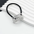 Detail of black elastic hair tie with silver twisted metal and white pearl embellishment - Small / Silver