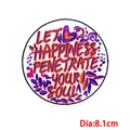 Detail of round 8.1cm embroidered patch with inspirational quote and colorful floral patterns - LET HAPPINESS/Dia 8.1cm