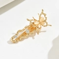 Close-up of golden metal butterfly hair clip with pink cat eye stone and clear rhinestones - Cat's Eye Butterfly Gold