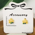Golden crown earrings with green and blue stones on an accessory display card - Crown Style