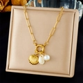 Close-up of gold shell and white pearl pendants on a stainless steel link chain necklace - Chunky Link Chain With Shells And Pearl (N3481)