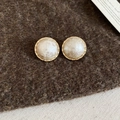 Detail of gold-plated geometric stud earrings with pearl centers on brown felt background - Beige Pleated (Gold Plated Silver Pin)