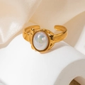 Close-up of a vintage gold ring featuring a colorful oval gemstone on a white pedestal - Iridescent Opal Oval Cabochon Style (TYR0847)