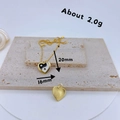 Detail view of gold-plated Yin Yang heart pendant showing weight 2g and size 20mm x 16mm - Black & White Tai Chi Heart