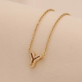 Detailed close-up of gold Y letter pendant with clear zircon on a delicate chain - Letter Y