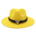 Close-up of yellow straw fedora featuring ethnic stripe band and silver bull head charm - Yellow