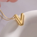 Gold balloon letter V pendant necklace with high-shine finish and delicate chain - Letter V