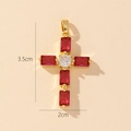 Detail view of a gold cross pendant with red gemstones and 3.5cm by 2cm dimensions - Style Y-Red & Clear Zirconia Cross