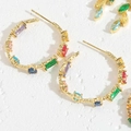 Macro view of gold hoop earrings with multi-colored crystals on a textured white surface - Colorful Zirconia Hoop Earrings (ES2282-30MM)