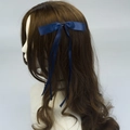 Elegant navy blue polyester bow hair clip with long ribbons on female model - Dark Blue