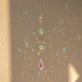 Silver galaxy crystal suncatcher with teardrop prism creating rainbow light on walls - Style 1 (38cm, 22g)