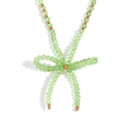 Handmade necklace with light green faceted crystals and golden steel beads bow - Grass Green Transparent