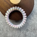 Spiral telephone cord hair tie with colorful clover pattern and macaroon stripes - Striped