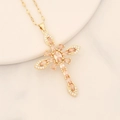Detail showing gold cross pendant with champagne zircon on a white plate - 6# Champagne