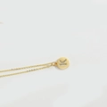 Minimalist gold necklace with a round letter K pendant and shimmering diamond inlay - Letter K