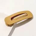 Close-up of matte ginger yellow hair clip with elegant minimalist hollowed-out design - Matte Hair Clip Large - Ginger Yellow
