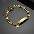Detail of gold stainless steel Cuban ID bracelet with crown charm on black mirror - Crown Pendant Bracelet-Gold