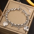 Close-up of a double-layer silver bracelet featuring beaded heart pendants and mixed chains - Silver Double Layer Heart Pendant Chain (LM011-1)