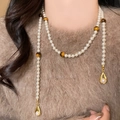 Detailed view of long pearl necklace with tiger eye beads and golden drop pendants - Teardrop Pearl Y-Shape Style (5# Necklace-White-Brown)