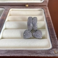 Silver heart earrings with shimmering pavé zircon studs displayed in a wooden jewelry box - E4431 Ear Buckle / Silver