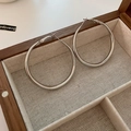 Polished silver C-shaped large hoop earrings with sparkling zircons in a wooden jewelry box - Silver Earring Post Silver Metal Hoop Earrings