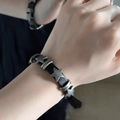 Star and cylinder metallic charms on a black leather bracelet for men and women - Dark Star Bracelet