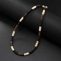 Close-up of bohemian men's turquoise coconut shell beaded necklace on dark background - Tri-Color Brown Cream Black Coconut Shell