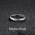 Polished silver Mobius loop ring for men with elegant twist design on a dark background - Mobius Strip-Twist Design