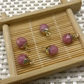 Five oval pink stone pendants with gold caps on a bamboo tray for DIY jewelry - No.21 Pink Agate