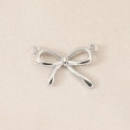 Macro shot of silver bow pendant with double hanging loops for DIY jewelry making - Slender Double Loop Bow (PJ0474) / Silver