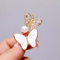 Golden butterfly brooch featuring white mother of pearl and shimmering zircon stones - Model XZ137