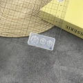 Macro view of transparent silicone mold with daisy patterns beside a ruler for scale - #175 Daisy