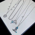 Detailed view of western style necklaces featuring turquoise boots and star charms - Silver