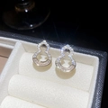 Detail of hollow gourd-shaped gold earrings with sparkling zircons on velvet - Gold