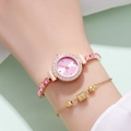 Detail of rose gold watch with pink dial and matching jewelry bracelet on a woman's wrist - Pink