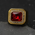 Detailed close-up of a men's gold ring with a square ruby and micro-pave crystals - Gold + Red Stone / US 7