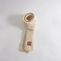 Kids warm knit scarf in cream beige color featuring a brown story book logo label - STORY BOOK Leather Label / Beige