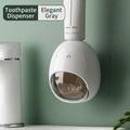 Wall-mounted automatic toothpaste dispenser in elegant grey with oval shape design - Elegant Grey