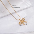 Golden stainless steel snake chain necklace featuring a beaded bow pendant and dimension labels - Beaded Bow 2514